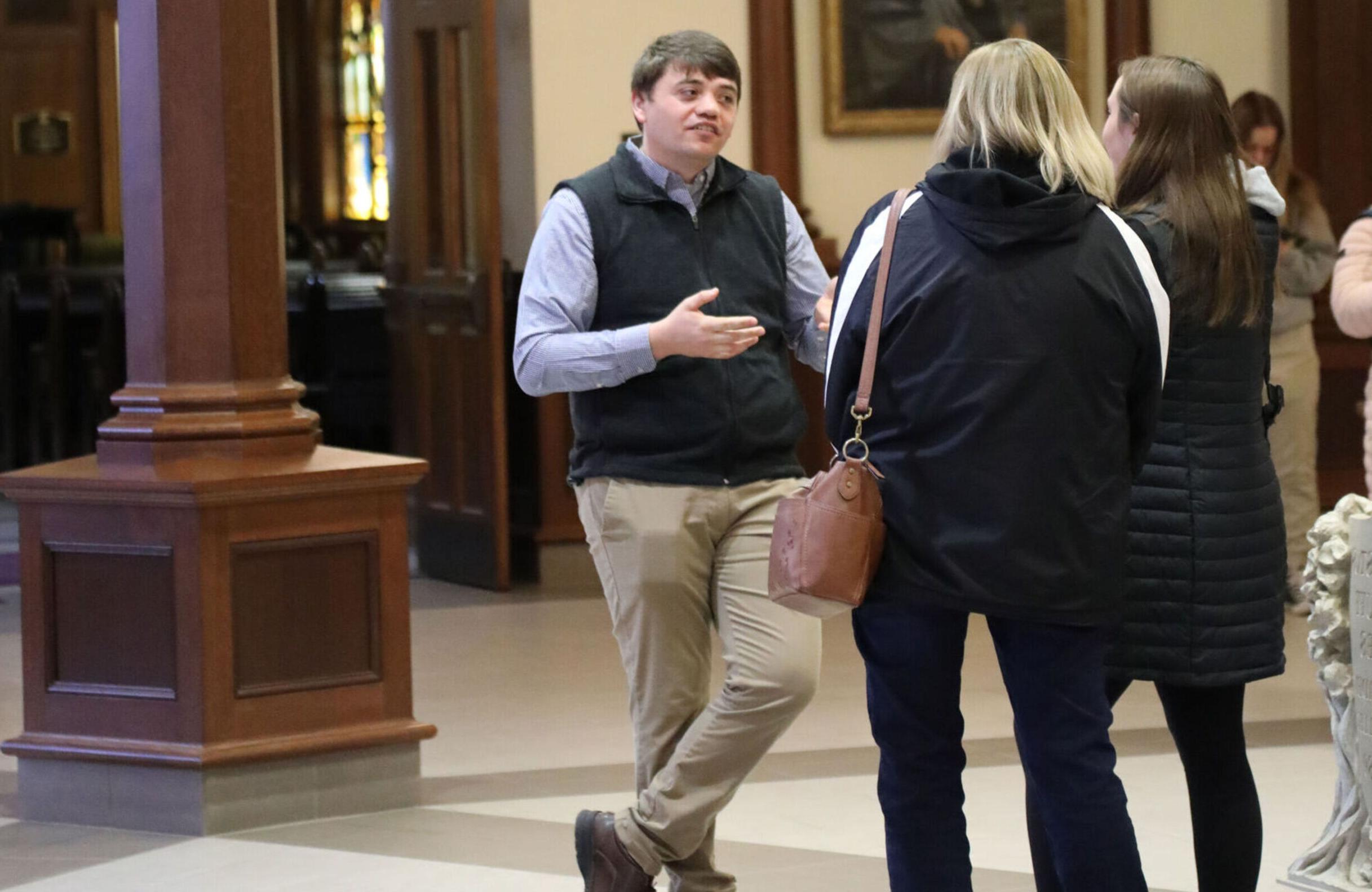 An Admissions Counselor speaks with visitors to the Nursing open house